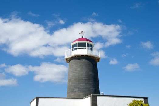 An Old Lighthouse in the Canary Islands with a sailing ship Weathervane