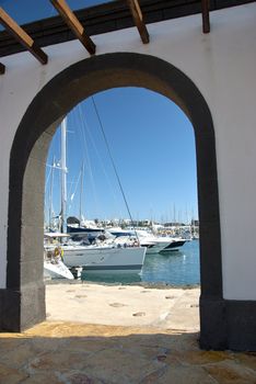 Luxury Yachts Framed by a centuries old Archway inthe Canary Islands