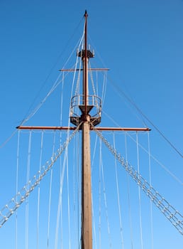 A Ships Mast and Rigging against a blue sky