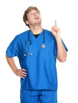 nurse or doctor pointing and looking up. Man wearing medical scrubs and stethoscope. Young caucasian male medical professional in his isolated on white background.