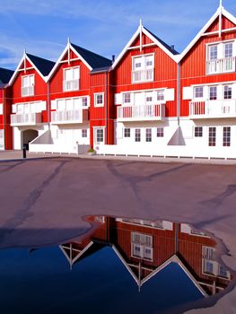 Modern classical design beach summer houses reflected perfectly in a small water pond digital art manipulation