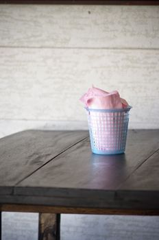 Budget napkin paper in blue basket on wooden table