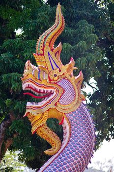 Native Lanna style ofDragon sculpture with tree background