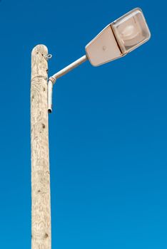 Street light isolated against a blue sky background