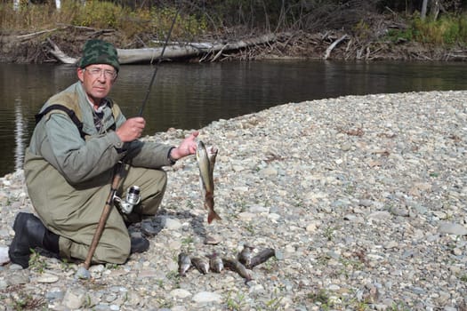 Fisherman after a successful fishing on the river