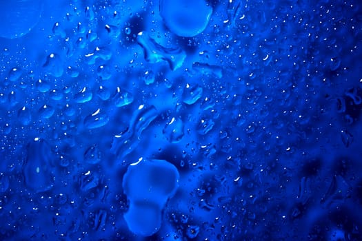 Abstract background of deep blue droplets and fluid elements.