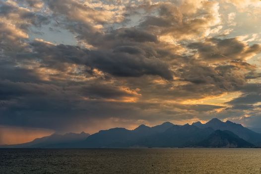Dramatic lanscape of a sunset over the mountains and the sea