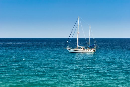 Small sailing yacht on the calm sea