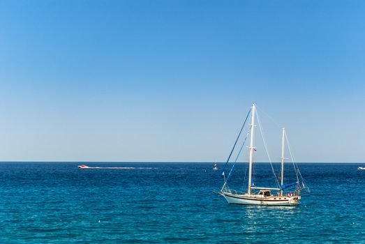 Small sailing yacht on the calm sea