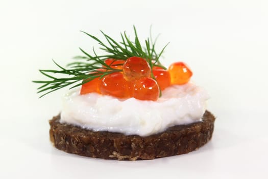 Pumpernickel with dill and caviar on a white background