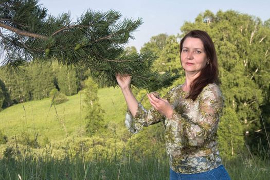 Portrait of the woman with a pine branch