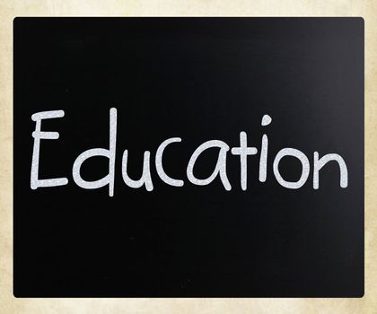 The word "Education" handwritten with white chalk on a blackboard