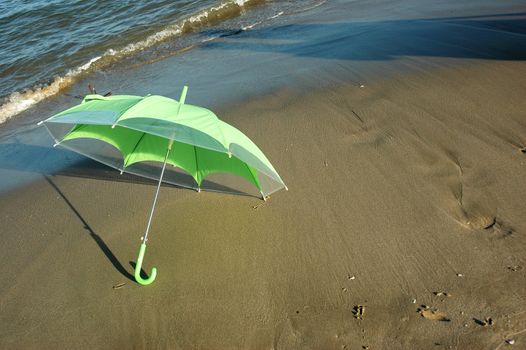 green umbrella on the beach