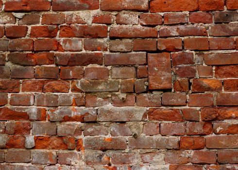 Old weathered brick masonry wall