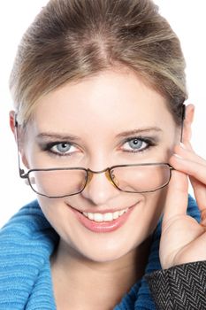 Beautiful woman’s face wearing glasses in a close up portrait