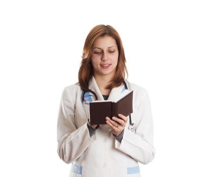 attractive female doctor taking notes on a pad on a white background isolated