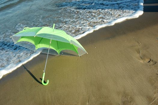 green umbrella on the beach