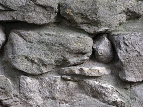 Fragment of old rustic cobblestone wall surface