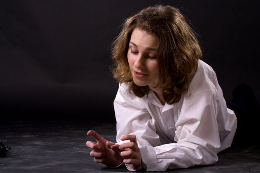 smiling lying woman on black background
