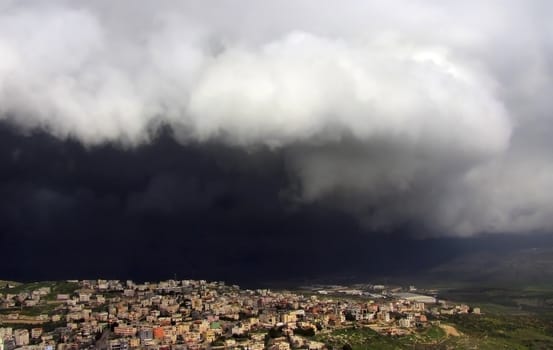 black storm cloud hanging over kfar Kana in Israel