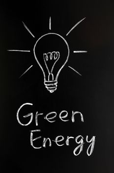 Light bulb drawn with chalk, symbol of innovation and green energy