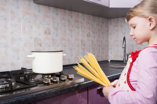 girl looking at pasta in the kitchen