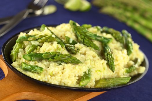 Green asparagus risotto (Selective Focus, Focus on the asparagus head one third into the risotto)