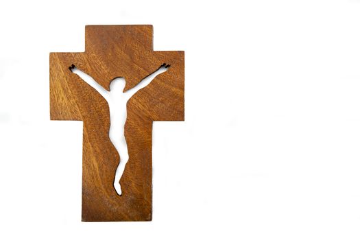 Modern wooden crucifix over a white backdrop