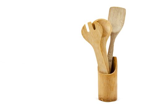 Wooden kitchen utensils over white backdrop