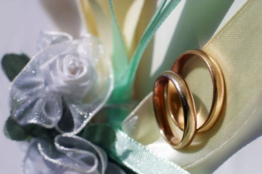 Wedding rings on a blue satiny fabric