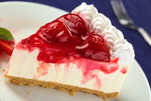 Fresh strawberry cheesecake (Selective Focus, Focus on the glazing running down on the left and the left side of the two strawberries in the front)