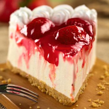 Fresh strawberry cheesecake (Selective Focus, Focus on the glazing running down on the left and the front of the first strawberry on the cake)