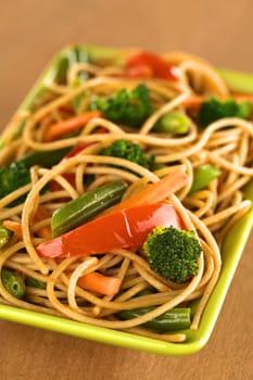 Vegetable and wholewheat spaghetti stir fry (Selective Focus, Focus on the broccoli floret in the front)