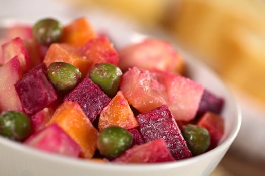 Russian beetroot salad made of beetroot, potato, carrot, pea and a mayonnaise dressing (Selective Focus, Focus one third into the bowl) 