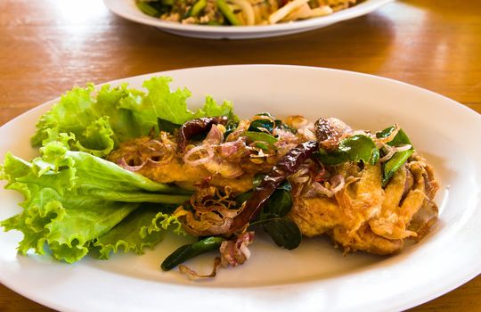 Fried fish with fresh herbs and spicy