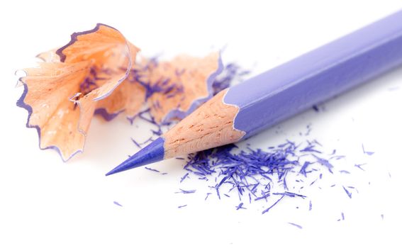 Color pencil with sharpening shavings on white background