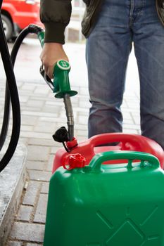 Man in jeans gas station in a plastic gasoline canister 98E