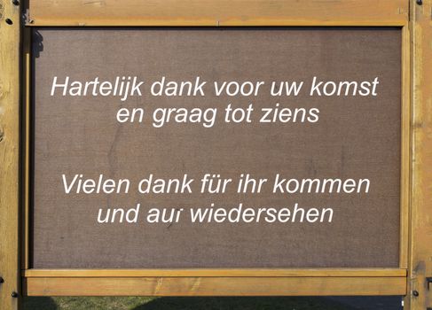 wooden plate with thank you fror coming in dutch en german language
