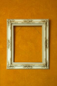 Blank antique ivory frame on orange painting background