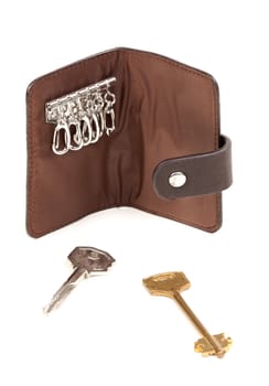 Brown purse for the keys with two keys. Isolate on white.
