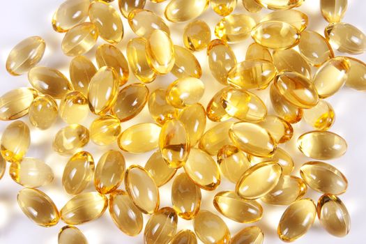 Yellow oil filled softgel capsules