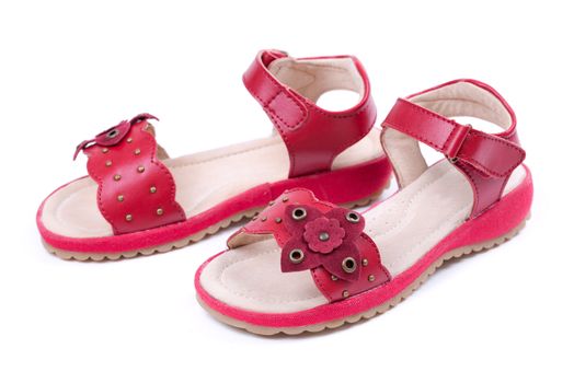 pair of red children's leather shoes on a white background