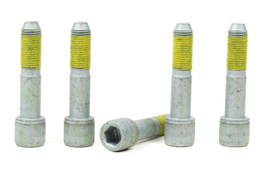 Five bolts for the car with the yellow glue on the threads. Isolate on white