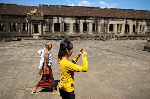A local Cambodian tourist photographing Angkor Wat, Cambodia.