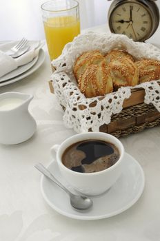  Morning cup of coffee with freshly baked rolls with sesame seeds, juice and milk