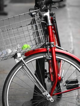 an old and red  bicycle in the street