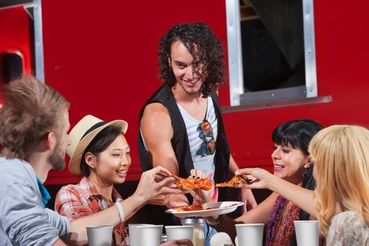 Happy group of people sharing slices of pizza