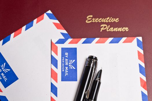 executive planner with two white by air mail envelopes in landscape orientation