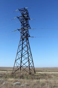 high voltage electricity pylon over blue sky