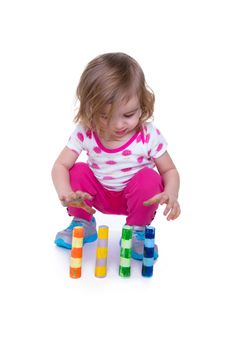 Toddler learning motor skills by paying attention to colorful crayons. Isolated on white with copy space.